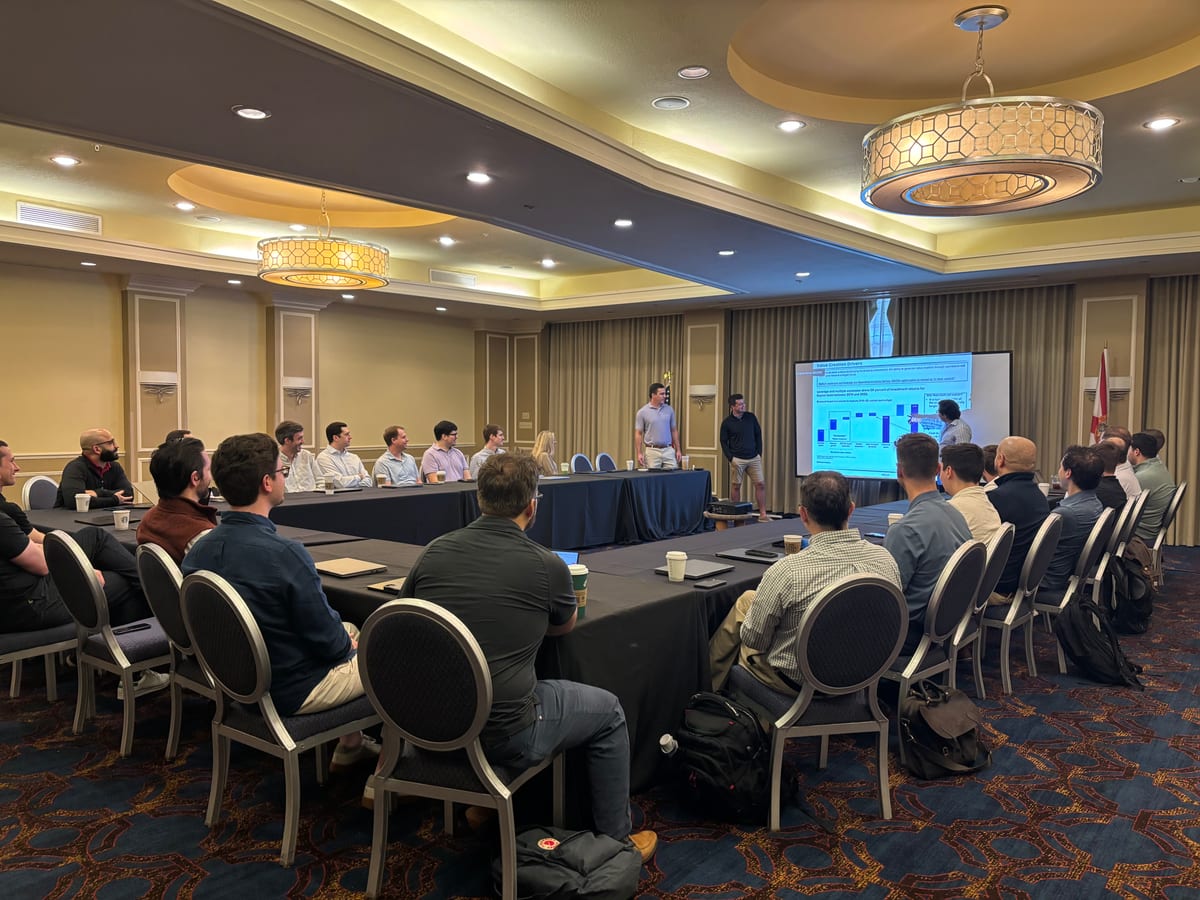 Waylin Partners team gathered around a U-shaped table during a strategy presentation at the Tampa offsite